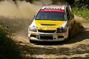 Andi Mancin / Maciej Wislawski drift their Mitsubishi Lancer Evo 9 through a hard right-hander on SS11.