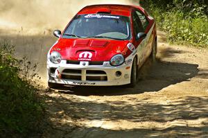 Lauchlin O'Sullivan / Karen Wagner drift their Dodge SRT-4 through a 90-right on SS11.