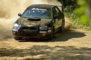 Pat Moro / Jeremy Wimpey drift their Subaru WRX STi through an uphill 90-right on SS11.