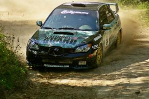 Mark Fox / Jake Blattner power out of an uphill 90-right on SS11 in their Subaru WRX STi.