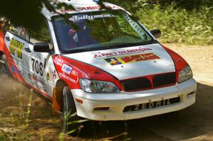 Jan Zedril / Jody Zedril take a fast uphill 90-right on SS11 in their Mitsubishi Lancer ES.