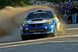 The Travis Pastrana / Christian Edstrom Subaru WRX STi rockets through the spectator location on SS12.