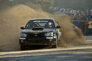 Pat Moro / Jeremy Wimpey spray gravel in their Subaru WRX STi at the spectator location on SS12.