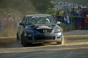 Wyatt Knox / Martin Headland fly through a right-hander at the spectator location on SS12 in their Mazda Speed 3.