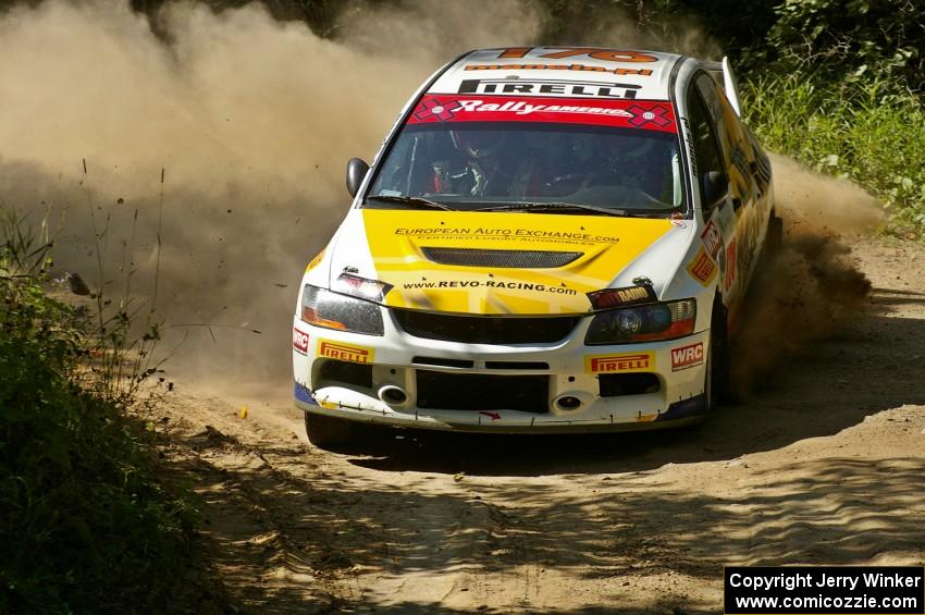 Andi Mancin / Maciej Wislawski drift their Mitsubishi Lancer Evo 9 through a hard right-hander on SS11.