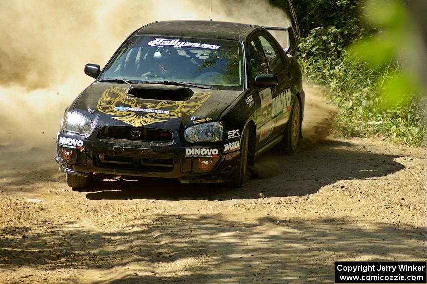 Pat Moro / Jeremy Wimpey drift their Subaru WRX STi through an uphill 90-right on SS11.