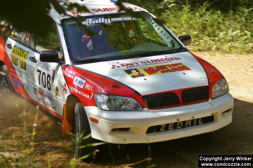 Jan Zedril / Jody Zedril take a fast uphill 90-right on SS11 in their Mitsubishi Lancer ES.