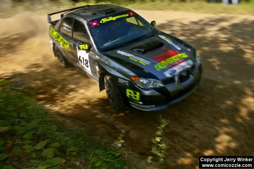 Jimmy Keeney / Missy Keeney at an uphill 90-right on SS11 in their Subaru WRX STi.