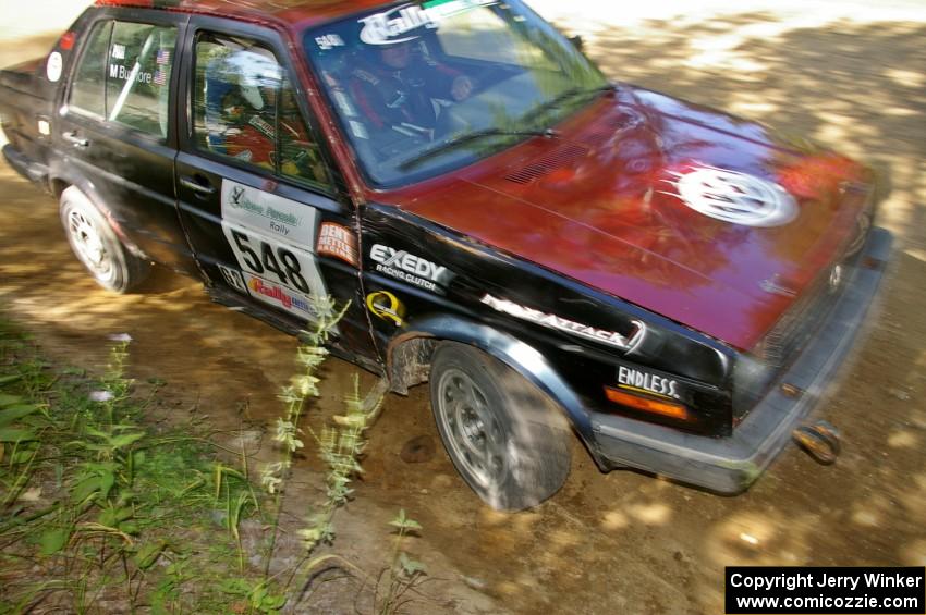 Matt Bushore / Kim DeMotte apex a right-hander on SS11 in their VW Jetta.