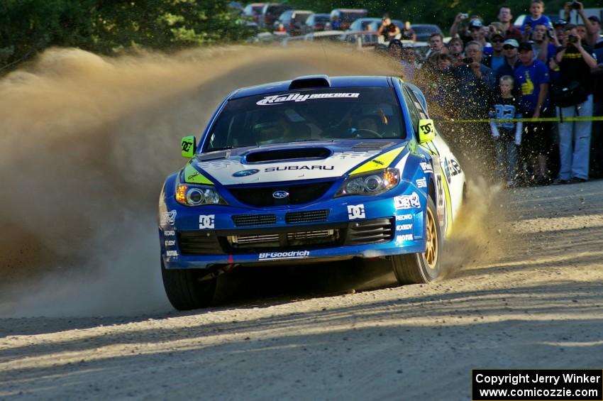 The Travis Pastrana / Christian Edstrom Subaru WRX STi rockets through the spectator location on SS12.