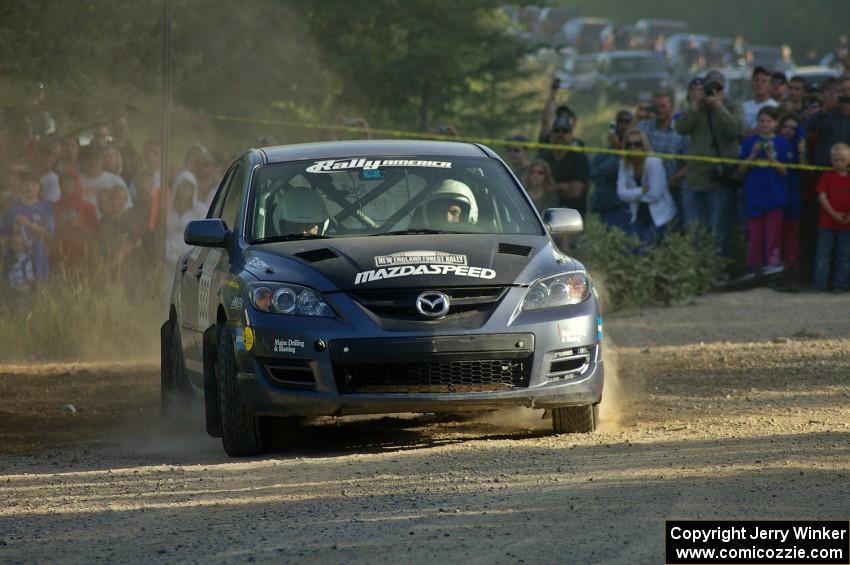 Wyatt Knox / Martin Headland fly through a right-hander at the spectator location on SS12 in their Mazda Speed 3.