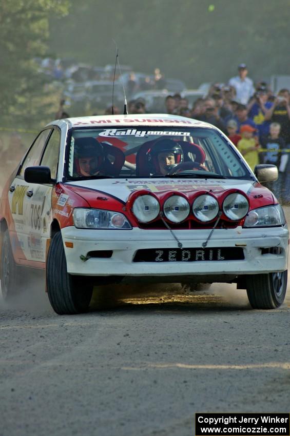 Jan Zedril / Jody Zedril come onto the county road spectator location on SS12 in their Mitsubishi Lancer ES.