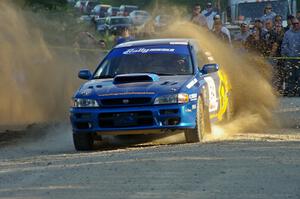 Piotr Fetela / Mariusz Malik slide their Subaru Impreza through the gravel for fans at the SS12 spectator point.