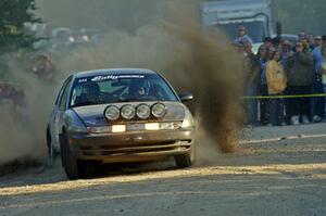 Dan Adamson / Matt Nichols kick up gravel at the SS12 spectator point in their Saturn SL2.
