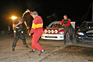 Wyatt Knox is dumped on by Kim DeMotte at the Max-Attack! victory champagne celebration while Jan Zedril looks on.