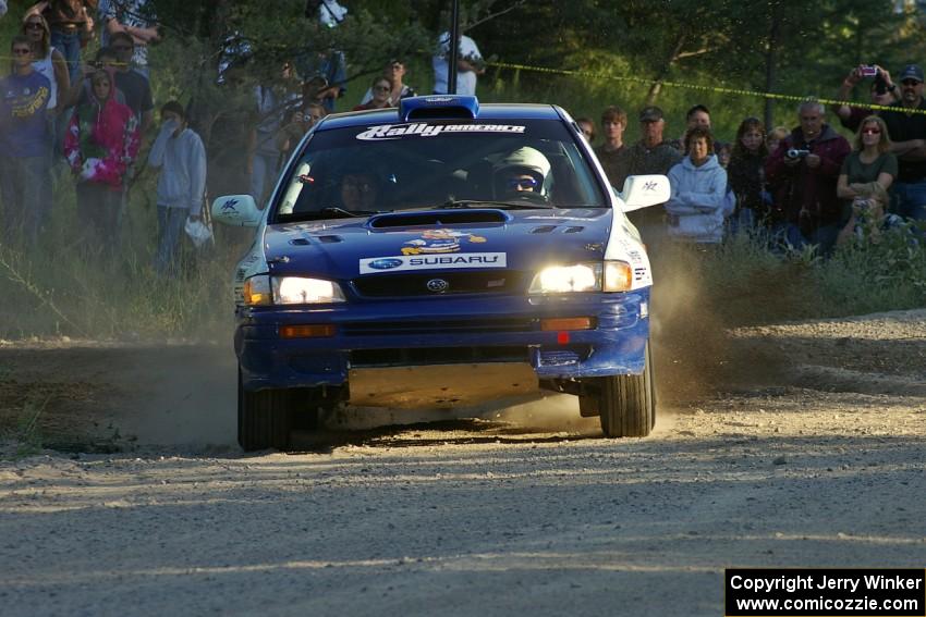 Mason Moyle / Scott Putnam Subaru Impreza drive onto the county road on SS12 as spectators watch.