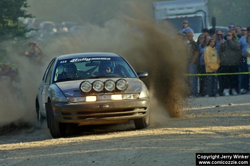 Dan Adamson / Matt Nichols kick up gravel at the SS12 spectator point in their Saturn SL2.