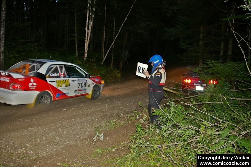 Jan Zedril / Jody Zedril in their Mitsubishi Lancer ES pass the stranded Mark Utecht / Rob Bohn Ford Mustang on SS15.