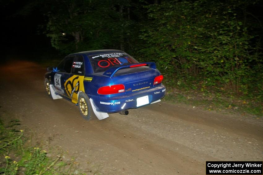 Piotr Fetela / Mariusz Malik fly down a straight on SS15 in their Subaru Impreza.