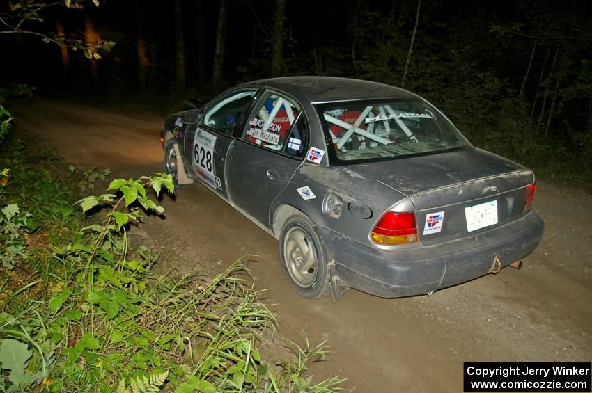 Dan Adamson / Matt Nichols in their Saturn SL2 on SS15 just after sundown.