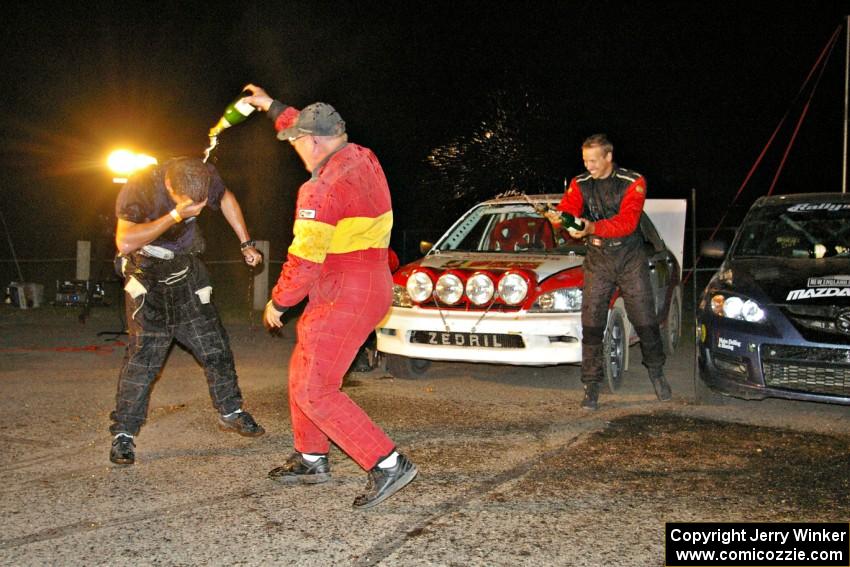 Wyatt Knox is dumped on by Kim DeMotte at the Max-Attack! victory champagne celebration while Jan Zedril looks on.