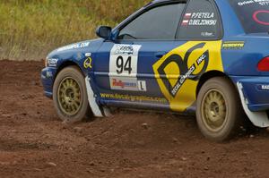 Piotr Fetela / Dariusz Belzowski blast their Subaru Impreza out of a tight left on the practice stage.