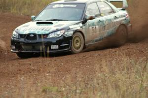 Mark Fox / Jake Blattner spray gravel at a corner on the practice stage in their Subaru WRX STi.