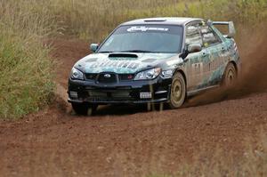 Mark Fox / Jake Blattner spray gravel at a sweeper on the practice stage in their Subaru WRX STi.