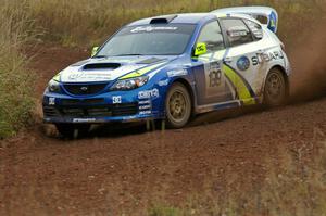 Travis Pastrana / Christian Edstrom drift their Subaru WRX STi hard through a tight corner on the practice stage.