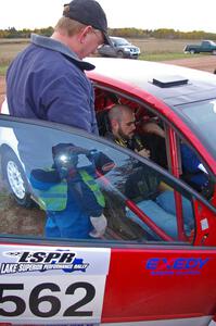 Dave Parps helps a rider get comfortable in the VW GTI-Rally of Brian Dondlinger.