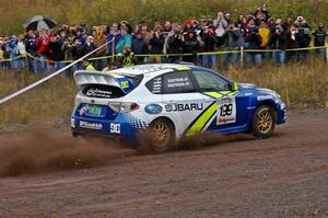 Travis Pastrana / Christian Edstrom blast out of the spectator corner on Green Acres, SS1, in their Subaru WRX STi.