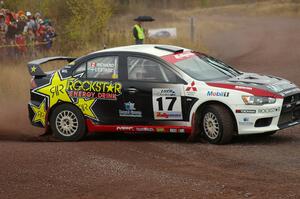 Antoine L'Estage / Nathalie Richard drift hard at the spectator corner on Green Acres, SS1, in their Mitsubishi Lancer Evo X.