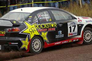 Antoine L'Estage / Nathalie Richard accelerate past spectators on Green Acres, SS1, in their Mitsubishi Lancer Evo X.