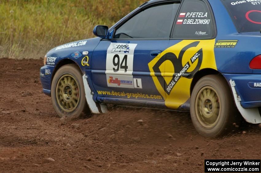 Piotr Fetela / Dariusz Belzowski blast their Subaru Impreza out of a tight left on the practice stage.