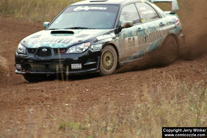 Mark Fox / Jake Blattner spray gravel at a corner on the practice stage in their Subaru WRX STi.