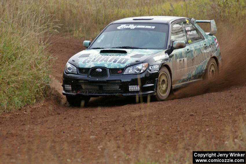 Mark Fox / Jake Blattner spray gravel at a sweeper on the practice stage in their Subaru WRX STi.