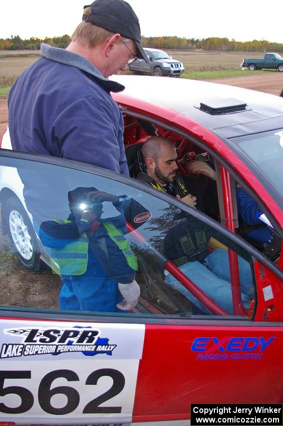 Dave Parps helps a rider get comfortable in the VW GTI-Rally of Brian Dondlinger.