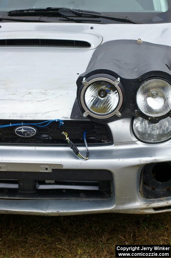 The Evan Cline / Jason Grahn Subaru WRX retuned after a roll at STPR. Scratches were still on the hood.