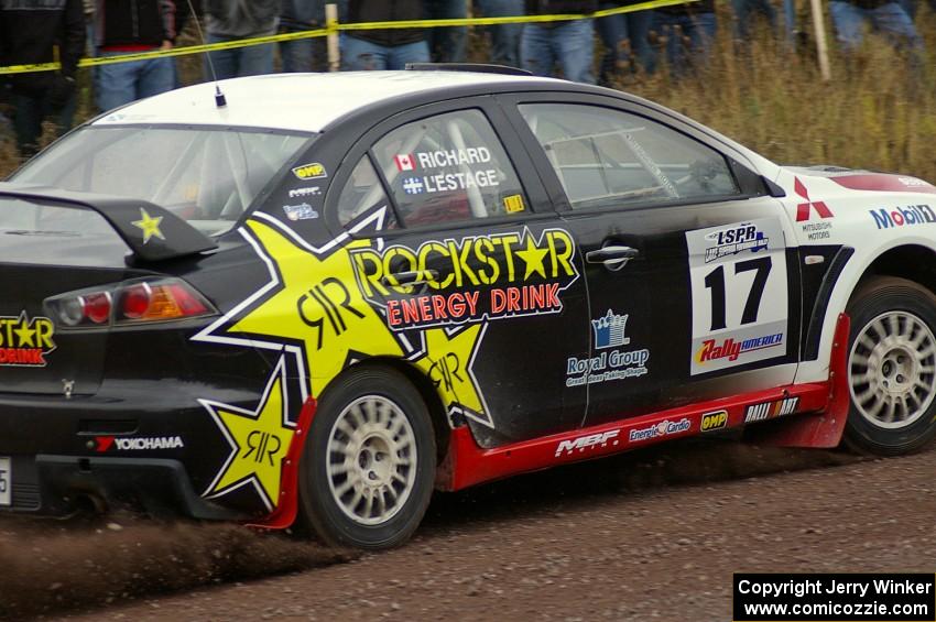 Antoine L'Estage / Nathalie Richard accelerate past spectators on Green Acres, SS1, in their Mitsubishi Lancer Evo X.