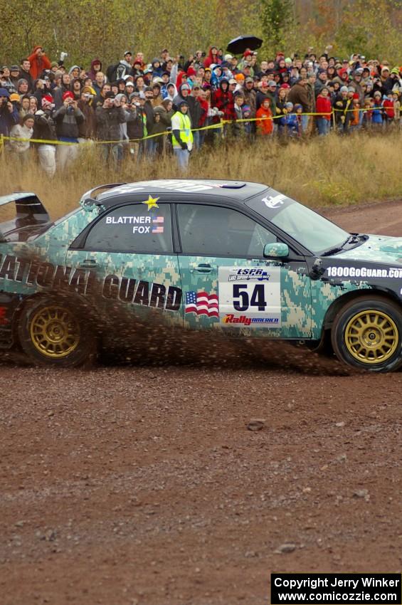 Mark Fox / Jake Blattner spray gravel at the spectator corner on Green Acres, SS1, in their Subaru WRX STi.