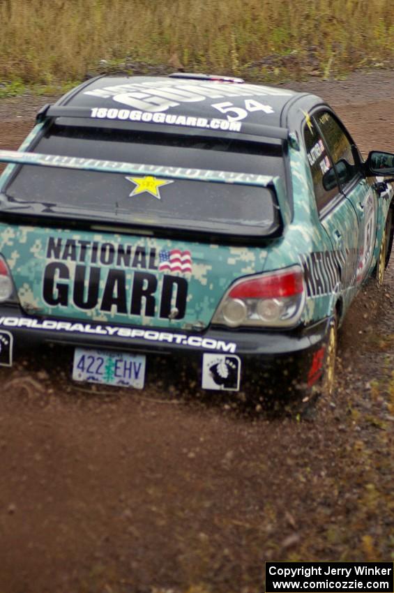 Mark Fox / Jake Blattner go wide at the spectator corner on Green Acres, SS1, in their Subaru WRX STi.