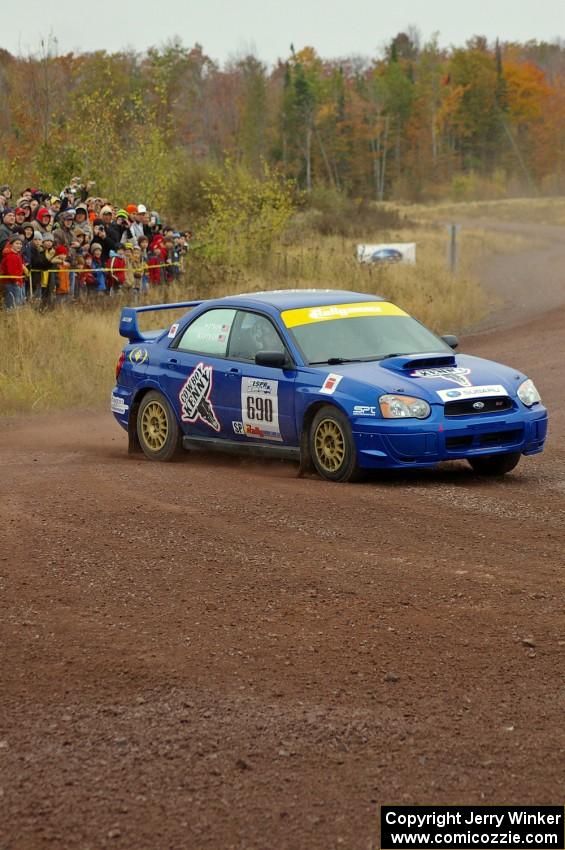 The Kenny Bartram / Dennis Hotson Subaru WRX STi goes past spectators on SS1, Green Acres.