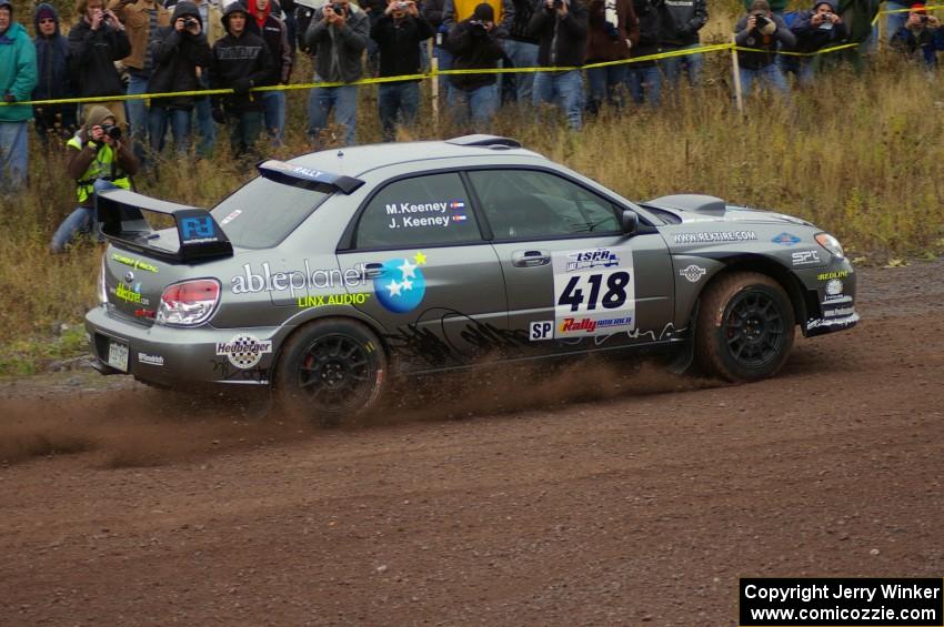 Jimmy Keeney / Missy Keeney blast out of the spectator corner on Green Acres, SS1, in their Subaru WRX STi.