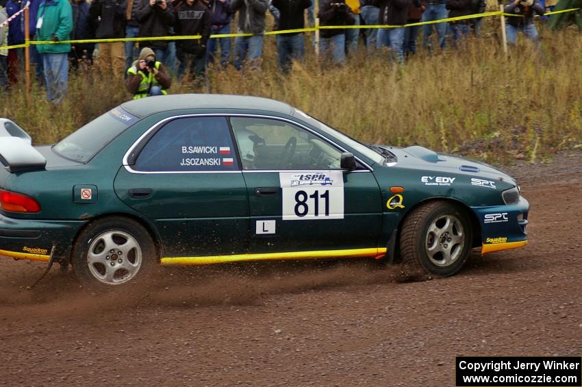 Jaroslaw Sozanski / Bartosz Sawicki drift their Subaru Impreza RS past the spectator point on Green Acres, SS1.