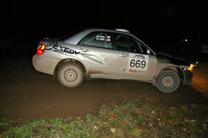 Evan Cline / Jason Grahn drift through the spectator corner on Far Point 2, SS7, in their Subaru Impreza.