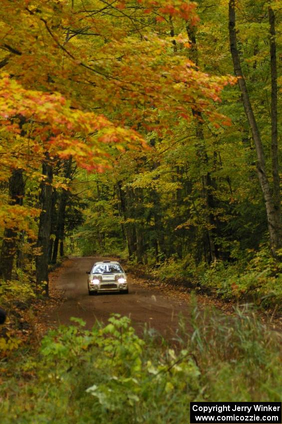 The Henry Krolikowski / Cindy Krolikowski Subaru Impreza at speed down a straight on Beacon Hill, SS2.