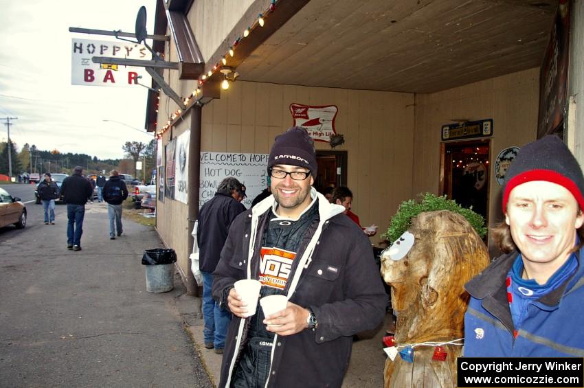 Andrew Comrie-Picard and Jeremy Wimpey enjoy a warm beverage in front of Hoppy's Bar at Kenton service.