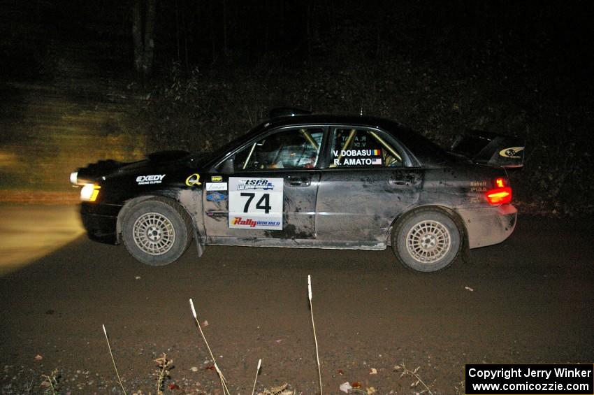 Vio Dobasu / Rob Amato at speed down a straight on Far Point 1, SS5, in their Subaru WRX STi.