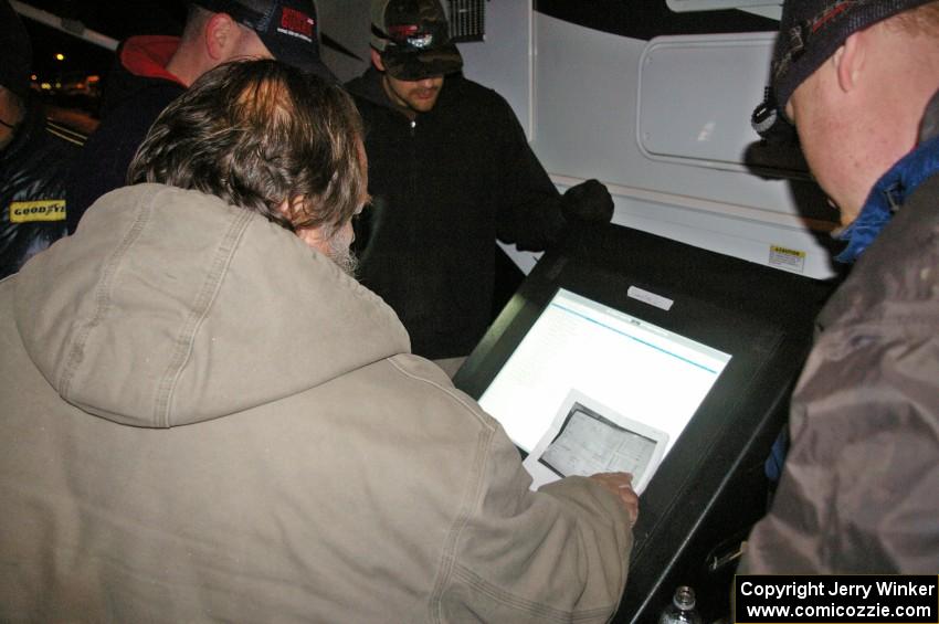 Checking scores outside the R-A motor home.