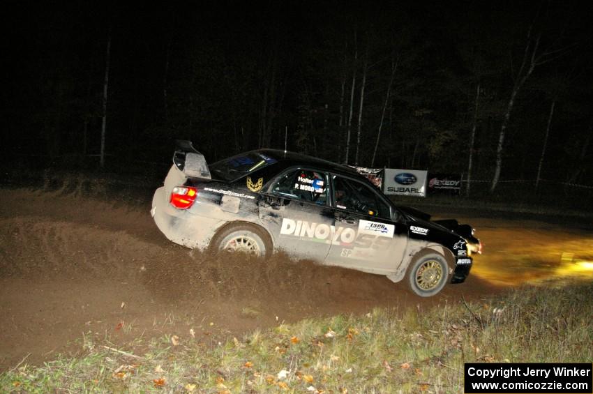 Pat Moro / Ole Holter drift hard through the spectator corner on Far Point 2, SS7, in their Subaru WRX STi.